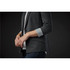 A women's grey knit blazer with rolled sleeves and a pocket, featuring a subtle branding logo.