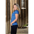 A woman poses in a blue Women's Apollo H2X-Dry Polo shirt, featuring short sleeves and a fitted style.