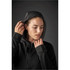A black women's hoodie with a zip front and a hood, featuring a person adjusting the hood. It has a simple design.