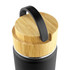 A drink bottle with a matte black body and a bamboo lid featuring a handle. It has a sleek and modern design.