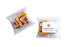 A clear pillow pack containing assorted rock candy pieces in purple and orange, with a logo on the packaging.