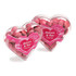 Acrylic heart container filled with pink chocolate beans, featuring a decorative heart-shaped design and a logo.