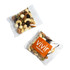 A clear pouch containing a mix of nuts, seeds, and dried fruits, featuring tones of brown, cream, and green.