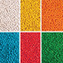 A collection of brightly coloured chewy fruit candies in six sections: white, yellow, orange, red, blue, and green.