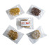 Five protein balls in clear packaging, featuring various colours and textures, with a logo on one pack.