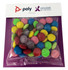 A clear bag filled with brightly coloured choc beans, including green, pink, yellow, and purple, on a branded backing.