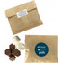 A kraft paper bag containing Lindt buttons and marshmallows, with a logo on the front.