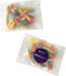 A packet of colourful gummy sour worms in pink, yellow, blue, and green, with a logo on the packaging.