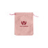 A pink velvet drawstring bag with a logo printed on the front. The bag has matching pink drawstrings.