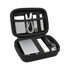 A black zipper case containing a portable charger, cables, a flashlight, and USB drives in a mesh pocket.