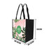 A tall non-woven tote bag featuring a floral design in pink and green, with black sides and handles.