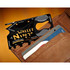 A black card-sized multi-tool with various functions, positioned inside a brown wallet, featuring a logo.