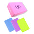 A pink EVA yoga block with a logo, accompanied by blue, purple, and neon green blocks.