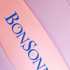 A pink and purple volleyball with a logo displayed prominently on it.