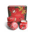 A set of four red tin candles in festive containers, displayed in a Christmas-themed box with decorations.