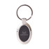 A silver oval keyring featuring a black insert and a logo on one side.