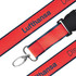 A detailed woven lanyard in red and black with a metal clip and a branded design.