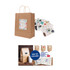 A kraft paper bag with twisted handles, featuring a decorative label, accompanied by assorted stickers.