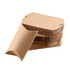 A stack of large brown kraft pillow boxes with one box leaning to the side, showcasing its curved design.