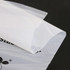 A transparent, biodegradable self-adhesive bag with a smooth surface and a subtle logo in the corner.