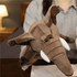 A plush elephant hand puppet in brown, featuring tusks and large ears, held by a person.