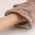 A plush frog hand puppet in soft tan fabric, with an opening for hand insertion. Features a simple logo on the side.