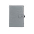A grey PU notebook with a clasp closure, featuring a smooth textured surface and a logo on the cover.