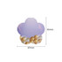 A flower-shaped sticky note in pastel purple with a design of gold and white bubbles at the bottom.