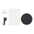 A round black wireless charger with a USB cable and a manual, all placed on a white background.
