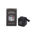 A Bluetooth speaker in black and silver, placed beside its packaging featuring a logo and product details.
