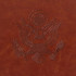A brown PU leather passport holder featuring an embossed emblem design. The texture appears smooth and luxurious.