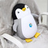 A penguin-shaped plush travel pillow in black, white, and yellow, featuring a small logo on its belly.