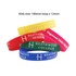 A variety of printed silicone wristbands in yellow, red, blue, and pink, featuring a logo and text.