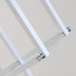 A close-up of a white metal frame with brackets and a connecting rod, designed for a backlit display.