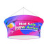 A circular hanging banner in vibrant pink and blue with sunglasses graphics and branding.