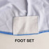 A close-up of a white and blue tablecloth featuring a foot set section. It includes a logo.