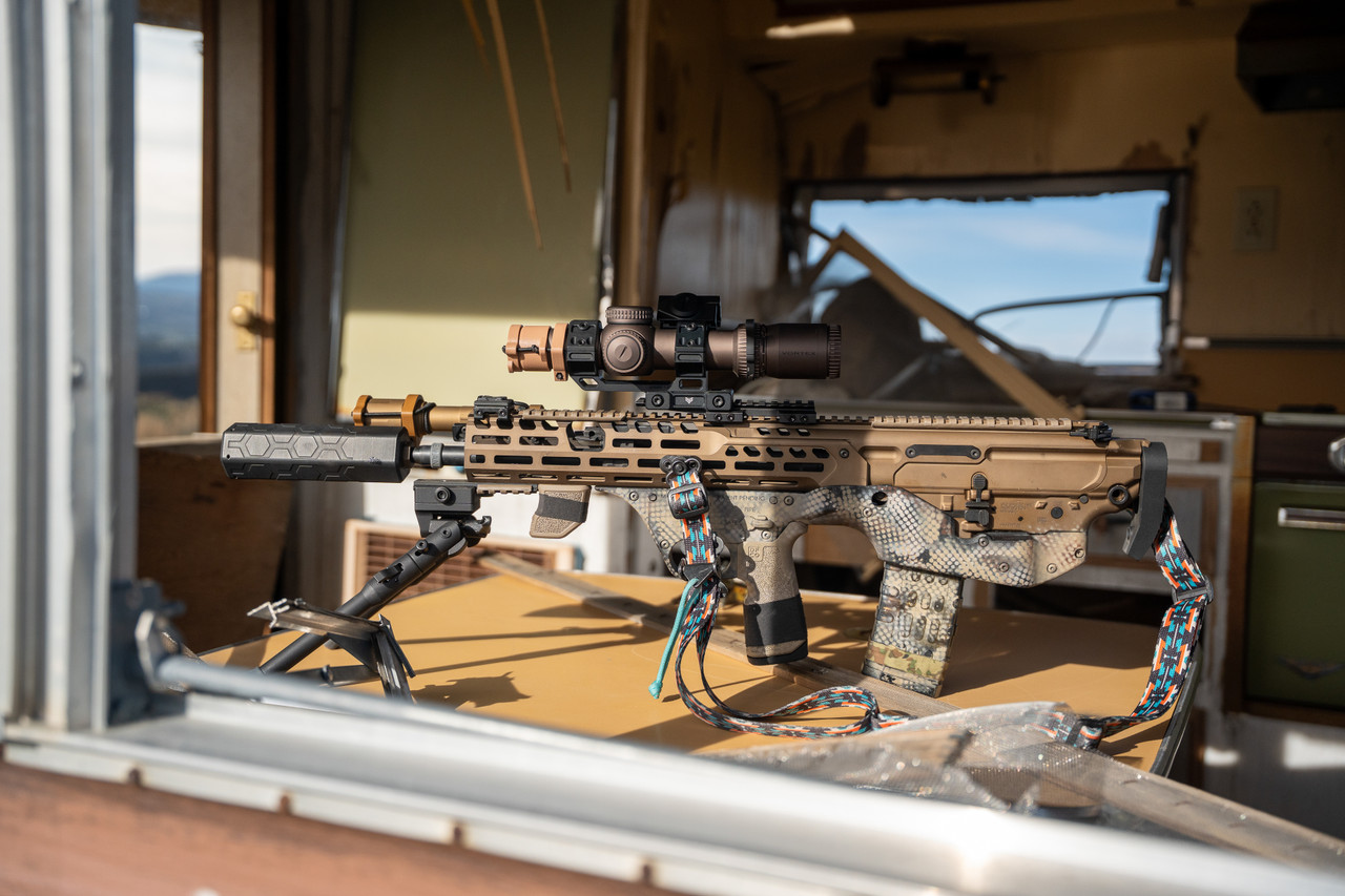 Our Smokey Suppressor mounted on an AR-15 rifle with a bullpup modification