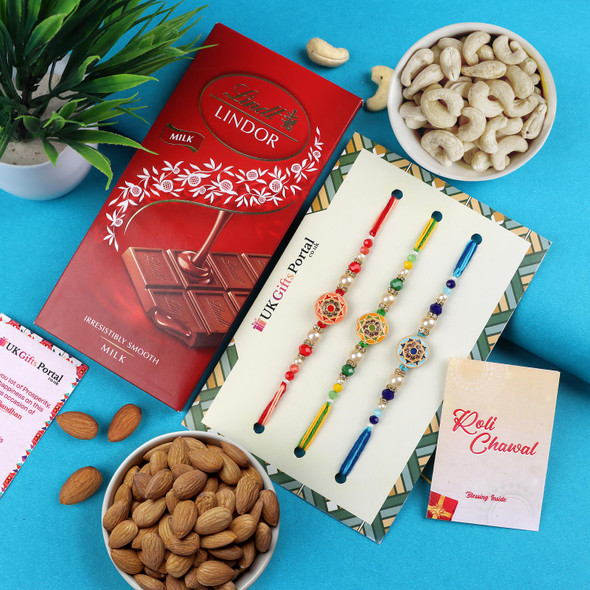 Picturesque 3 Rakhi Set with Chocolate & Dry Fruits - For Singapore