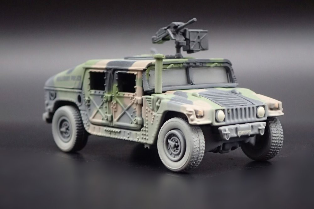 M1025 HMMWV Armament Carrier HUMVEE 4-CT Armored Fastback, Battle Worn Camo Green - Johnny Lightning - 1/64 scale Diecast Model Toy Car
