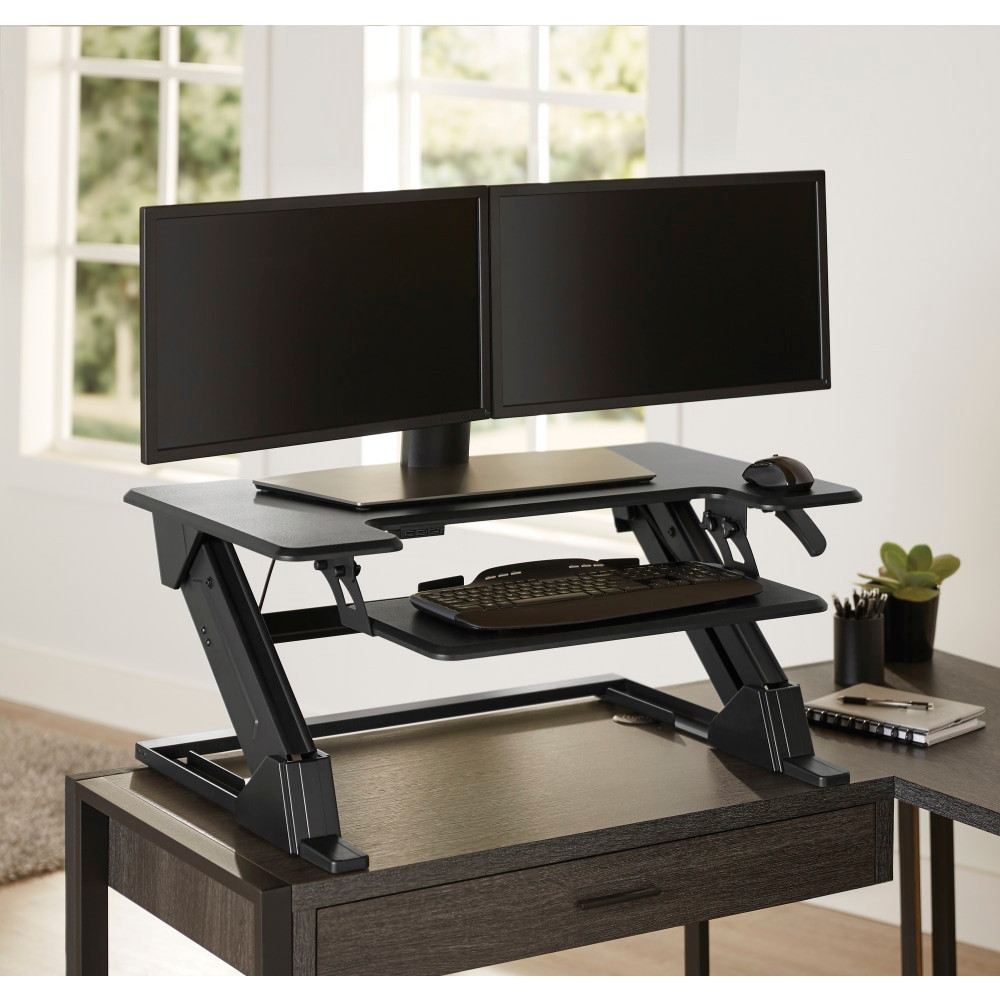Place this Realspace Standing Desk Converter on your worktable or desk to transform it into an active workstation. With the pneumatic lift-assist, you can easily transition from sitting to standing and back again, as the riser can move between 5.1in and 19.3ft" above your work surface. You will also be able to maintain a comfortable typing position because the removable keyboard tray moves in accordance with the top surface. Plus, 3 USB ports are located under the desk surface to allow you to easily connect your peripherals.  Ergonomic design with you in mind - choose your comfort level and get more done.  Sturdy MDF construction with steel hardware.  Removable keyboard tray moves up and down to match the work surface.  Cord management system helps maintain a tidy work space.  1-touch pneumatic lift assist lets you raise or lower the riser between 5.1in and 19.3ft".  3 USB ports under the desk surface.  Freestanding design.  Weight capacity tested to support 33 lb.  Assembly required.  Tested to meet ANSI/BIFMA Performance Standards - Manufacturer testing has been conducted on this product to meet specific performance requirements and safety standards set forth by the American National Standards Institute (ANSI) and the Business and Institutional Furniture Manufacturers.