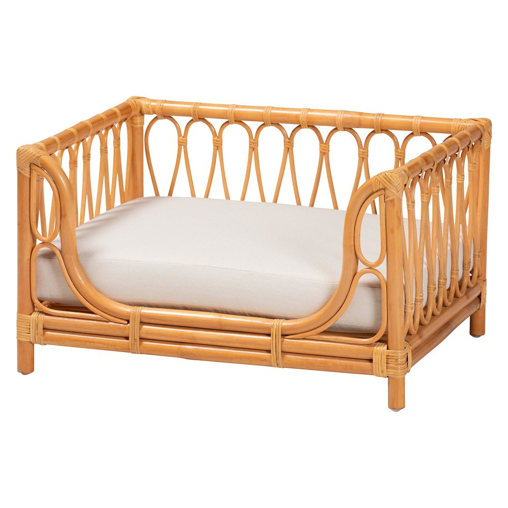 Give pets the comfort they deserve with a bali & pari Kierra Bohemian Rattan Pet Bed. The bed is constructed from natural rattan that complements a variety of living spaces and features an openwork frame so pets can hop on and off as they please.  Made of natural rattan.  Openwork frame with rattan decor embellishments and a raised border so pets can come and go as they please.  Foam-padded cushion is removable for cleaning.  Save time - no assembly required.