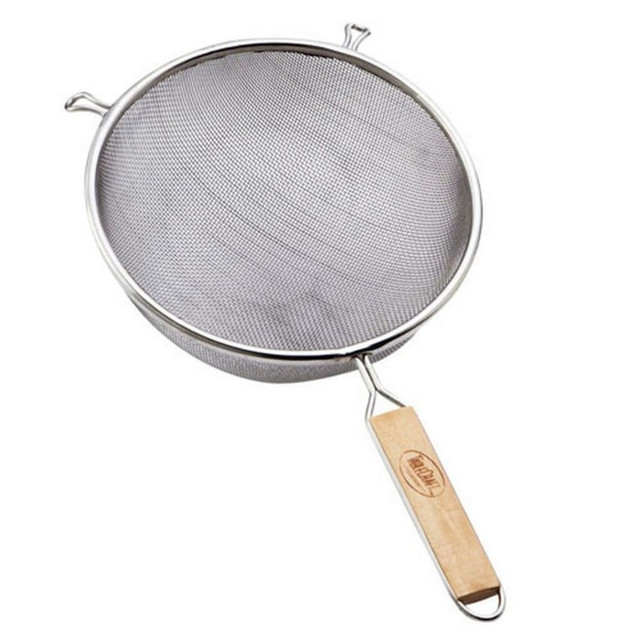 Having a strainer in your kitchen allows you to drain meals quickly to keep them tasting as they should. This strainer is made of tin-plated single mesh and features a sturdy wood handle.  Tin-plated single mesh allows liquids to drain out.  Wooden handle lets you use it with hot foods without burning your hand.  Hand wash only.
