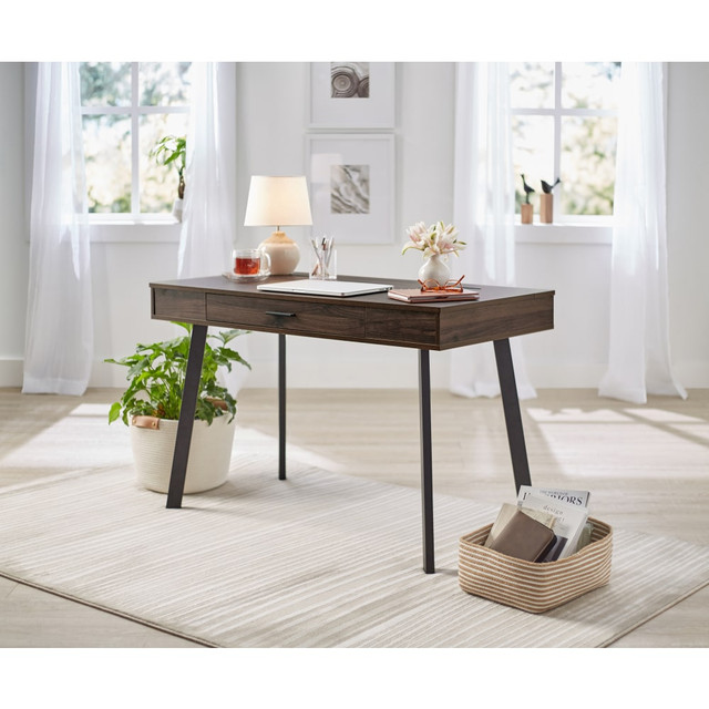 Create a comfortable working environment with this 48-inch Realspace Lancott computer desk. A drawer offers ample storage for your paper documents and phone chargers, while the cable management system helps organize cords for a neat workspace. The modern design complements various decor themes. This Realspace Lancott computer desk has a compact profile that fits in small spaces seamlessly.  Metal frame offers stability and durability.  Laminate desktop resists scuffs and offers a smooth working surface.  1 file drawer frees up space on your desktop.  Cable management system helps declutter the working surface.  Assembly required.  Tested to meet ANSI/BIFMA Performance Standards - Manufacturer testing has been conducted on this product to meet specific performance requirements and safety standards set forth by the American National Standards Institute (ANSI) and the Business and Institutional Furniture Manufacturers.  Interested in in-home assembly? Please call our certified and insured professional assemblers 866-388-4350 today!