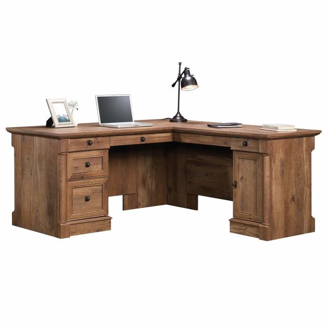 An efficient work area can help ensure that everything you need is within easy reach during a busy day. This versatile Sauder L-shaped desk give you the space you need to keep office supplies handy inside the storage drawer and organize your files in the full-extension file drawer. The side door of this Palladia Collection desk reveals a storage area with an adjustable shelf that can be uses to hold extra paper or even your CPU.  Engineered wood construction for durability.  Flip-down keyboard/mouse panel easily tucks away.  3 storage drawers and 1 file drawer holds office essentials and documents.  Cabinet with adjustable shelf can be used to conceal a CPU.  This product is heavy and/or oversized and may need more than one person to handle.