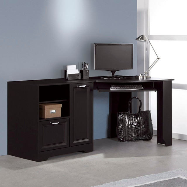 Create an office that fosters productivity with this Magellan Collection corner desk at the heart of it all. The spacious desktop provides ample room to tackle large projects, and the storage areas help you stay organized. The cabinet with an adjustable shelf can be used to house your tower, and the open shelving is great for stashing notebooks, blank discs and other office supplies. Thanks to the file drawer, its easy to keep important documents by your side.  MDF construction with a laminate finish.  Cabinet with an adjustable shelf.  Adjustable open shelving.  File drawer accepts letter- (8-1/2in x 11in) and legal-size (8-1/2in x 14in) files.  Compatible with other Magellan pieces for a cohesive look (sold separately).  Assembly required.  Espresso finish.  Inner drawer color may vary.  Tested to meet ANSI/BIFMA Performance Standards - Manufacturer testing has been conducted on this product to meet specific performance requirements and safety standards set forth by the American National Standards Institute (ANSI) and the Business and Institutional Furniture Manufacturers.  This product is heavy and/or oversized and may need more than one person to handle.  Interested in in-home assembly? Please call our certified and insured professional assemblers 866-388-4350 today!