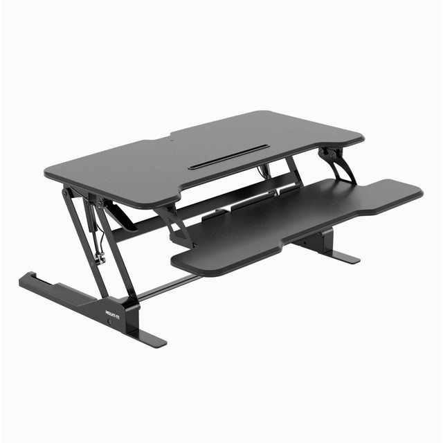 Add movement to your working day by converting your traditional desk or table into a dynamic sit-stand desk instantly. Alternating your position between sitting and standing throughout the day can help you work more healthy and increase productivity. Thanks to its gas spring technology this standing desk converter can be easily adjusted to your preferred height by holding down the lever. The extra wide, high quality MDF platform with rounded edges allows you to place either a widescreen monitor, two monitors or a monitor and a laptop to create your ideal workspace. The integrated grommet hole lets you install a monitor mount, too. The lower keyboard platform is wide enough to hold a large keyboard with number pad plus your mouse on a mouse pad. A built-in device channel holds your tablet or smartphone securely in place and even allows for routing your charging cable through the integrated slots. Integrated rubber feet ensure your tabletop remains free from scratches.  Turn your traditional desk into an active sit-stand workstation with this 38in wide standing desk converter  High quality, contemporary design with rounded edges fits perfectly into any office or home interior  Smooth, gas spring height adjustment between 5.9in and 16.9in  Integrated device channel allows you to keep your tablet or smartphone in sight  Large platform provides enough space for 2 monitors or one monitor and one laptop  Wide keyboard tray holds a large keyboard and provides space for a mouse pad  Backed by the manufacturers lifetime limited warranty.