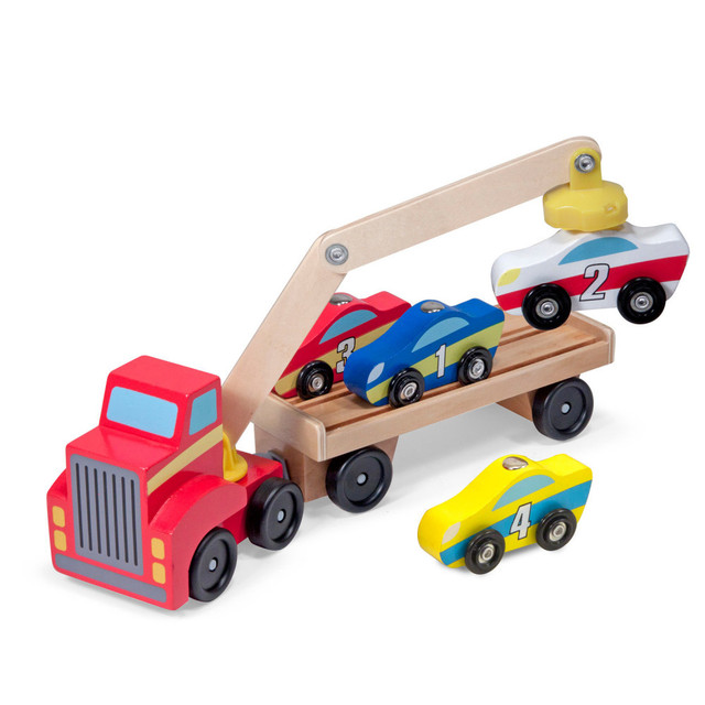 This big red wooden truck with a magnetic arm is perfect for car- and truck-loving kids, offering hours of loading, unloading, and imaginative play! The set includes a red truck with a magnetic arm, a car-carrier trailer, and four magnetic cars, each with unique colors, stripes, and numbers to inspire counting, sorting, and sequencing. The detachable trailer keeps cars secure during travel, making it a fun way to enhance fine motor skills and hand-eye coordination.  Sturdy wooden vehicle set for hours of loading and unloading fun  Includes red truck with magnetic arm, car-carrier trailer, and 4 magnetic wooden cars  Each car features unique colors and numbers to inspire counting, sorting, and sequencing  Detachable trailer has stabilizing tracks to keep cars in place during motion  Great for developing fine motor skills and hand-eye coordination  Smooth-rolling wheels for endless play and imaginative adventures