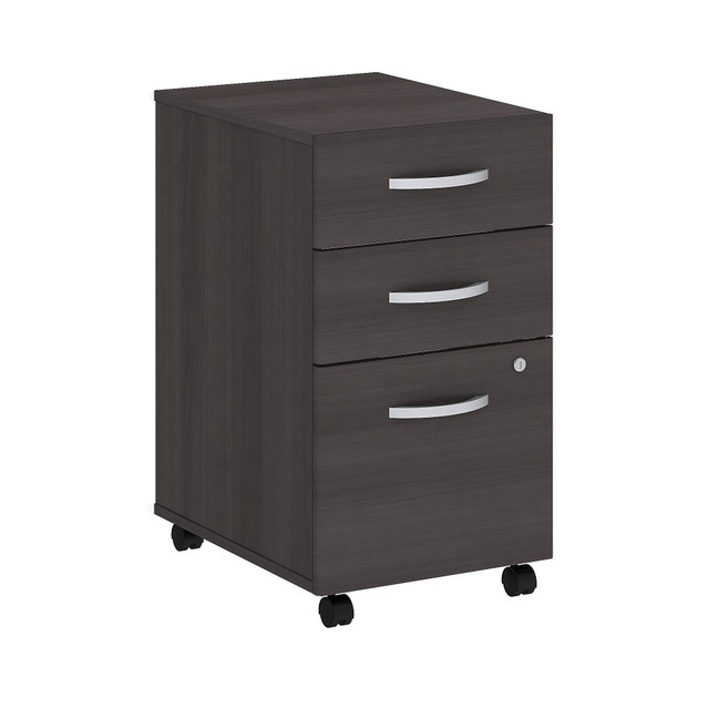 The Studio C Mobile File Cabinet rolls with you throughout your office. Dual-wheeled, hooded casters keep the cabinet moving wherever you want or remain in place on your office floor or carpet. You will have your paperwork organized in no time as the Mobile File Cabinet ships fully assembled.  Assembled Dimensions: 15 5/7inW x 20 1/6inD x 27 7/8inH  Thermally fused laminate finish fends off scratches and stains.  Mobile File Cabinet rolls wherever you need it on two fixed and two swivel casters.  Brushed Nickel hardware complements your choice of several attractive finishes for a contemporary or traditional look.  File drawer glides on smooth full-extension ball-bearing slides so you will easily access letter, legal and A4-size paperwork.  37-lb weight capacity per file drawer.  2 box drawers store a variety of office supplies.  Single lock secures lower two drawers for your privacy.  Commercial quality backed by the Bush Business Furniture 10 Year Warranty. For additional information, please visit: www.bushbusinessfurniture.com/ReturnsExchanges.  Standard Delivery Service - Partially Assembled. Furniture is delivered partially assembled.  3 Drawer Mobile File Cabinet ships fully assembled for your convenience.  Assembly Required.  Standard Delivery Service. Furniture is delivered unassembled.  Tested to meet ANSI/BIFMA Performance Standards - Manufacturer testing has been conducted on this product to meet specific performance requirements and safety standards set forth by the American National Standards Institute (ANSI) and the Business and Institutional Furniture Manufacturers.