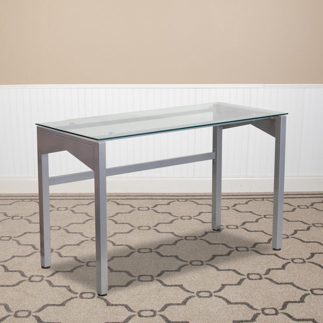 This modern glass computer desk is a stylish addition to your home office space. With plenty of room for your computer and office essentials, this desk will quickly become a favorite.  Supportive metal frame with a powder-coat finish.  Spacious 7-mm-thick tempered-glass desktop can accommodate your computer, office supplies and other accessories.  Plastic floor glides prevent damage to floors when the desk is moved.  Small desk - recommended for a small or shared space.  Assembly required.  Tested to meet ANSI/BIFMA Performance Standards - Manufacturer testing has been conducted on this product to meet specific performance requirements and safety standards set forth by the American National Standards Institute (ANSI) and the Business and Institutional Furniture Manufacturers.