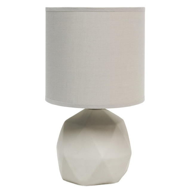 Brighten up your work space with the stylish Simple Designs Geometric Concrete Lamp. A fabric drum shade creates warm light, while the geometric base adds a unique personality to any room.  Concrete geometric base.  Fabric drum shade.  Requires 1 type B 40W candelabra base bulb (not included).  Rotary on/off switch located on the cord.  Stylish gray design.